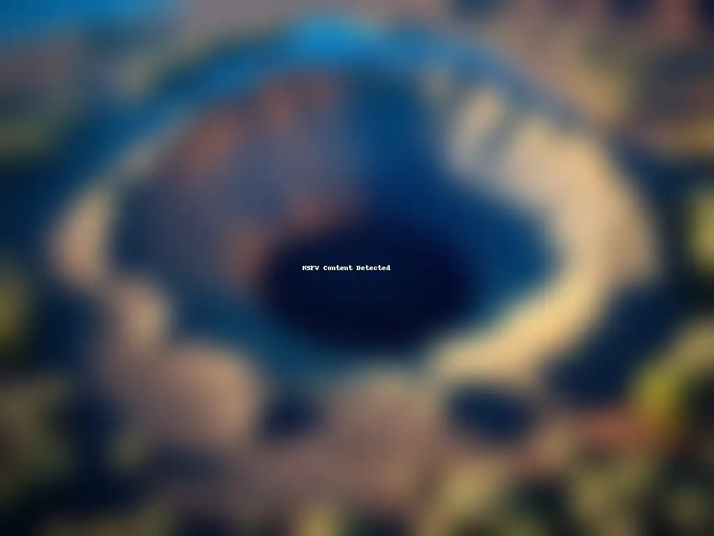A breathtaking aerial view of an asteroid crater on Earth's surface, surrounded by rugged terrain, rock formations, and lush trees